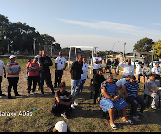 Outdoor community meeting with members seated